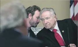  ?? Rich Pedroncell­i Associated Press ?? A S S E M B LY M A N James Gallagher, left, confers with Sen. Jim Nielsen in a briefing on the dam. Gallagher called the earthen spillway’s failure “a design f law.”