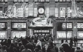  ?? Gabriela Bhaskar / New York Times ?? Black Friday shoppers wait to enter the flagship Macy’s store in Manhattan before dawn on Friday. After a dreadful COVID-19 year, retailers hope their sales improve, in-store and online.