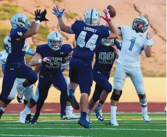  ?? GREG SORBER/JOURNAL ?? Cleveland QB Angelo Trujillo (1) throws under pressure against La Cueva on Thursday night at Wilson Stadium. The Bears romped over the Storm.