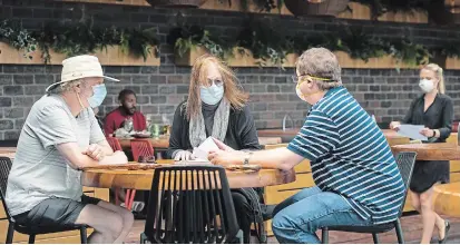  ?? NATHAN DENETTE THE CANADIAN PRESS FILE PHOTO ?? Patrons sit on the patio at Joey Sherway in Toronto in June. With the province imposing tighter restrictio­ns amid a second wave of COVID-19, some southern Ontario restaurant­s are making the tough financial choice of barring tourists from indoor dining.