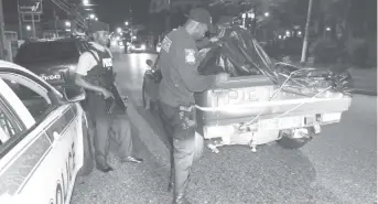  ??  ?? A police officer searches a vehicle during Operation Strike Back on Ariapita Avenue, Port-of-Spain on Saturday. TTPS