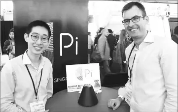  ??  ?? Pi co-founders Lixin Shi (left) and John MacDonald pose for a picture at a TechCrunch Disrupt technology conference in San Francisco with the world’s first wireless charger that does away with the need to lay devices on charging mats. — AFP photo