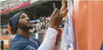  ?? BRIAN CASSELLA/CHICAGO TRIBUNE ?? Bears linebacker Robert Quinn signs autographs after a preseason game on Aug. 13 at Soldier Field.