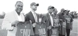  ?? CHARLES TRAINOR JR ctrainor@miamiheral­d.com ?? Dolphins executive Nat Moore, left, joins in the announceme­nt that Florida Memorial University will begin playing football in Miami Gardens in 2020.