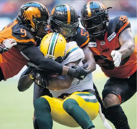  ?? DARRYL DYCK/THE CANADIAN PRESS ?? B.C.’s Jordan Herdman, centre, helps tackle the Eskimos’ C.J. Gable last Friday at B.C. Place. The Lions’ starting middle linebacker was picked in the seventh round of the CFL draft.