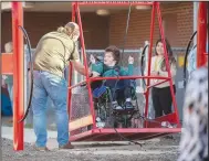  ?? (NWA Democrat-Gazette/J.T. Wampler) ?? Randall Lane of Springdale helps his son, Logan Lane, swing Monday on a wheelchair swing at Sonora Elementary School in Springdale. The swing has four wheelchair tie-downs to secure the chair when the swing rocks and also has a rope for the students to self-propel. Visit nwaonline.com/photo for today’s photo gallery.