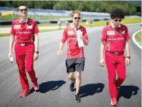  ??  ?? German Formula One Ferrari driver Sebastian Vettel, center, inspects racetrack ahead of the Austrian Formula One Grand Prix at the Red Bull Ring in Spielberg, Austria, on Thursday. (AFP)