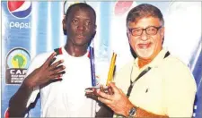  ??  ?? Managing Director, Seven-Up Bottling Company, Mr. Sunil Sawhney (right), presenting the Pepsi Man-of-the-match award to Senegalese midfielder, Babacar Fall, at the CAF Beach Soccer Nations Cup Final in Lagos... last Sunday