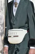  ?? Picture: Getty Images ?? A model walks the runway at the Gucci Cruise 2018 show with the line’s take on the moon bag.