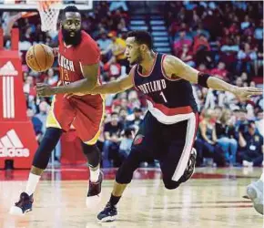  ??  ?? Rockets’ James Harden (left) attempts to go past Blazers’ Evan Turner in their NBA match in Houston on Thursday.