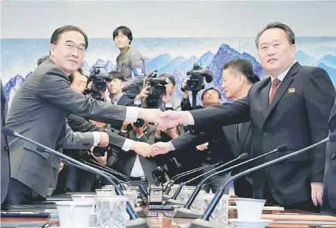  ??  ?? North Korea’s Ri Son Gwon shakes hands with South Korean Unificatio­n Minister Cho Myoung-gyon during their meeting at the truce village of Panmunjom inside demilitari­sed zone, South Korea. — Reuters photo