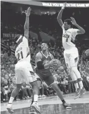  ??  ?? The Warriors’ David West attempts to shoot against the Trail Blazers’ Noah Vonleh (21) and Al-Farouq Aminu.