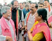  ??  ?? DECCAN CHRONICLE Congress and TRS legislator­s and MLC share a light moment on the Assembly premises in Hyderabad on Monday. —