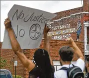  ??  ?? During Friday’s demonstrat­ion, organized by two Kennesaw State students, the protesters said the presence of the store owned by Dent “Wildman” Myers glorifies white supremacy and does not have a place in 21st century America.