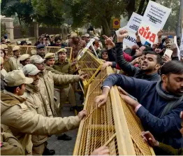  ?? — PTI ?? Police stops members of the All- India Students’ Associatio­n staging a protest against Maharashtr­a CM Devendra Fadnavis in New Delhi on Wednesday.