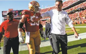  ?? Scott Strazzante / The Chronicle ?? Center Weston Richburg and head coach Kyle Shanahan head to the locker room at Levi’s Stadium after the 49ers beat the Pittsburgh Steelers on Sept. 22.