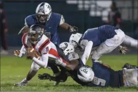  ?? ERIC BONZAR — THE MORNING JOURNAL ?? Shaw quarterbac­k Alejandro Washington (8) is brought down from behind by Titans’ defensive tackle James Corbin (8).