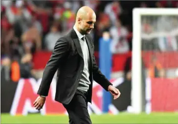  ?? PASCAL GUYOT/AFP ?? Manchester City manager Pep Guardiola walks off the pitch at halftime during his team’s UEFA Champions League round of 16 match against Monaco at the Stade Louis II in Monaco on Wednesday.