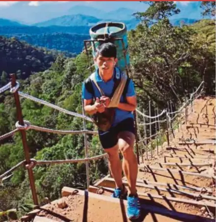  ?? PIC COURTESY OF JVY MIUS ?? Jvy Mius, carrying a heavy load, treks his way up to the Panalaban base camp of Mount Kinabalu.