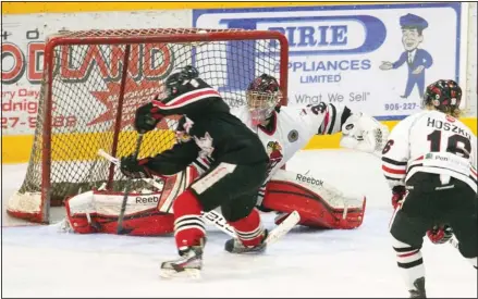  ?? JULIE JOCSAK ?? Thorold Blackhawks goalie Vinny Merante stops a shot during Game 4 of the junior B quarter-final Wednesday against Niagara Falls. Merante and Canucks goalie Hunter Johnson were both excellent as the Canucks won 3-2 in OT and moved one win away from the...