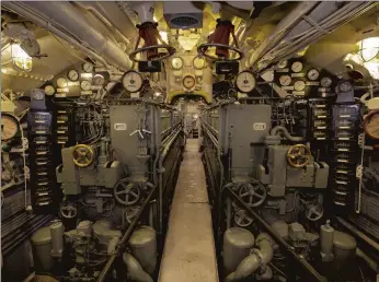  ?? MUSEUM OF SCIENCE AND INDUSTRY ?? A narrow path leads through the engine room of the U-505 submarine exhibit at the Museum of Science and Industry in Chicago, which now has virtual guided tours.