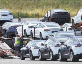  ?? Ben Margot / Associated Press ?? Tesla reports that it is on target to deliver a halfmillio­n vehicles this year. Its thirdquart­er profit was more than double that in the same quarter last year.