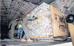  ?? LACW EMMA SCHWENKE/AUSTRALIAN DEFENSE FORCE ?? Humanitari­an aid is unloaded Thursday at Fua’amotu Internatio­nal Airport in Tonga following last Saturday’s volcanic eruption.