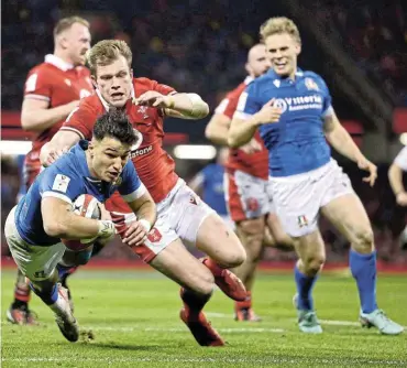  ?? Picture: Warren Little/Getty Images ?? Lorenzo Pani of Italy scores his team’s second try during the Six Nations defeat of Wales at Principali­ty Stadium in Cardiff, Wales yesterday.