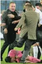  ?? /Reuters ?? Putting the boot in: MKE Ankaragucu President Faruk Koca, left, reacts as the referee Halil Umut Meler lies on the ground.