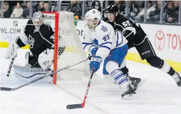  ??  ?? Maple Leafs forward Nazem Kadri tries for a wrap-around on Kings goalie Martin Jones while being tied up by defenceman Jeff Schultz during the first period in Los Angeles on Monday.