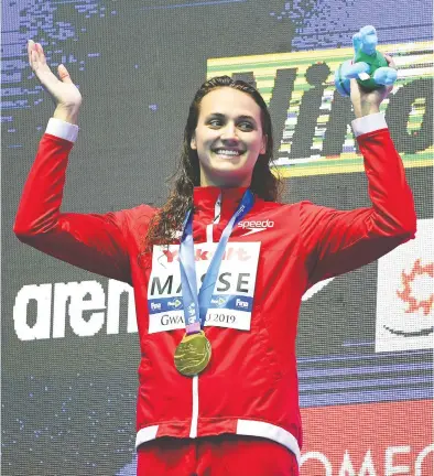  ?? QUINN ROONEY / GETTY IMAGES ?? Gold medallist Kylie Masse of Canada shows her delight during the medal ceremony Tuesday for the Women’s 100m
Backstroke Final, on Day 3 of the Gwangju 2019 FINA World Championsh­ips in Gwangju, South Korea.