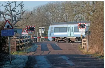  ?? PETER FOSTER. ?? A Greater Anglia Class 170 passes Kiln Lane level crossing (near Ely) on January 22. Level crossings are one of the biggest headaches facing Network Rail in East Anglia, with blanket closures simply not an option.