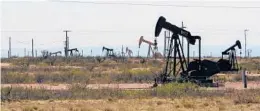  ?? JERI CLAUSING/AP 2014 ?? Oil rigs near Artesia, N.M. The state is the No. 2 crude producer in the U.S. and the top recipient of U.S. payments for fossil fuel production on federal land.