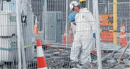  ?? Photo: IAIN McGREGOR/FAIRFAX NZ ?? Work came to a halt on an inner-city constructi­on site in Christchur­ch yesterday after an asbestos pipe was found.