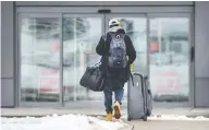  ?? PETER J THOMPSON / NATIONAL POST ?? A traveller arrives at the mandatory quarantine hotel
near Toronto's Pearson Airport on Monday.