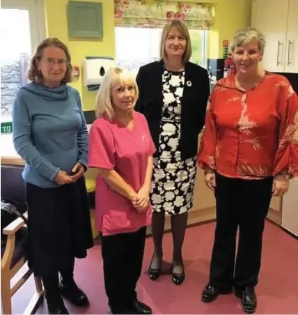  ??  ?? > Sue Jordan, left, professor of medicines management and health services research at Swansea University’s College of Human and Health Sciences, with staff at Monkstone House Care Home and Older People’s Commission­er for Wales Helena Herklots