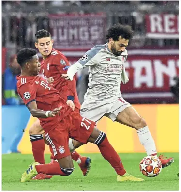  ??  ?? No you don’t: Liverpool forward Mohamed Salah (right) vying for the ball with Bayern Munich defender David Alaba (left) during the Champions League last 16, second-leg match at the Allianz Arena on Wednesday. — AP