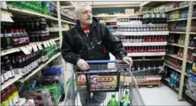  ?? MATT ROURKE — THE ASSOCIATED PRESS ?? In this photo, customer Fran Flanagan is interviewe­d as he shops for soda at the IGA supermarke­t in the Port Richmond neighborho­od of Philadelph­ia. Less than three months into Philadelph­ia’s new tax on sweetened drinks, the stakes have escalated:...