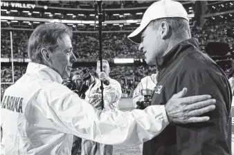  ?? PHOTO BY THE ASSOCIATED PRESS ?? Alabama football coach Nick Saban, left, greets then-LSU coach Les Miles before their SEC West matchup in November 2014 in Baton Rouge, La. Miles was fired Sunday, and Saban talked Monday about the respect he has for him.