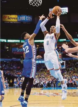  ?? APPIC ?? Oklahoma City Thunder’s Russell Westbrook takes a shot despite close attention from Philadelph­ia 76ers Richaun Holmes on Wednesday.