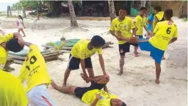  ??  ?? The Tacloban players help each other warm up befor a game (above) and pray together following the championsh­ip win (top).