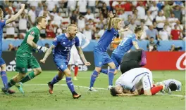  ??  ?? NICE: In this June 27, 2016 file photo, Iceland players celebrate winning at the end of the Euro 2016 round of 16 soccer match between England and Iceland, at the Allianz Riviera stadium in Nice, France. Iceland, a country of roughly 300,000 people,...