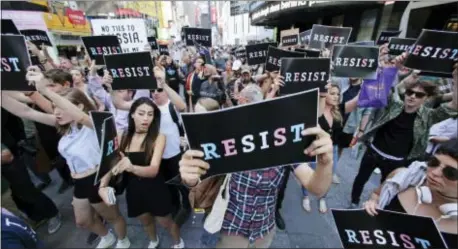  ?? ASSOCIATED PRESS ?? Protesters gather in New York’s Times Square on July 26 after President Donald Trump declared a ban on transgende­r troops serving anywhere in the U.S. military, catching the Pentagon flat-footed and unable to explain what it called Trump’s “guidance.”...