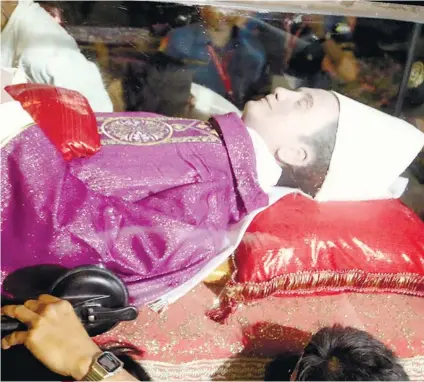  ?? SUNSTAR FOTO / ALEX BADAYOS ?? ‘BURIAL.’ The coffin containing the late Archbishop Teofilo Camomot’s remains and wax effigy was sealed and buried in a special tomb at the Domus Teofilo.