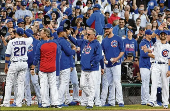  ?? AP ?? The Cubs acknowledg­e fans after their last regular-season game Sunday. The defendingW­orld Series champs start the postseason Friday vs. the Arizona-Coloradowi­nner.