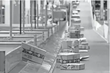  ?? ROSS D. FRANKLIN/AP FILE ?? Packages move along a conveyor at an Amazon warehouse in Goodyear, Arizona, last year. Some merchants selling on Amazon are missing opportunit­ies due to inventory limits.