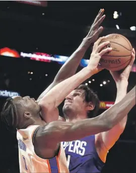  ?? Ringo H.W. Chiu Associated Press ?? BOBAN MARJANOVIC came of the bench for the Clippers to score 13 points in 16 minutes. Coach Doc Rivers said he likes the way his team competes.