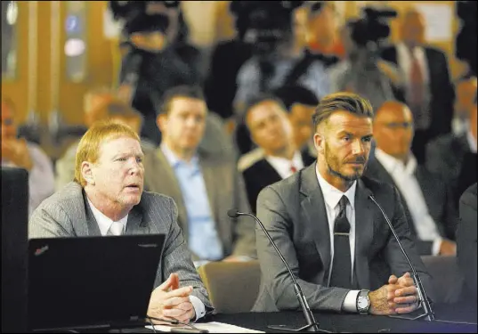  ?? BRETT LE BLANC/LAS VEGAS REVIEW-JOURNAL FOLLOW @BLEBLANCPH­OTO ?? Soccer great David Beckham, right, and Oakland Raiders owner Mark Davis, left, speak with the Southern Nevada Tourism Infrastruc­ture Committee about a multi-use stadium during a meeting April 28 at UNLV.