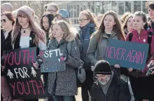  ?? PETER LEE WATERLOO REGION RECORD ?? Preston High School students hold signs at a rally Friday in support of U.S. students who are lobbying for stricter gun control laws.