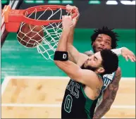  ?? Michael Dwyer / Associated Press ?? The Celtics’ Jayson Tatum dunks against the Hornets’ Miles Bridges during the first half of Sunday’s game.